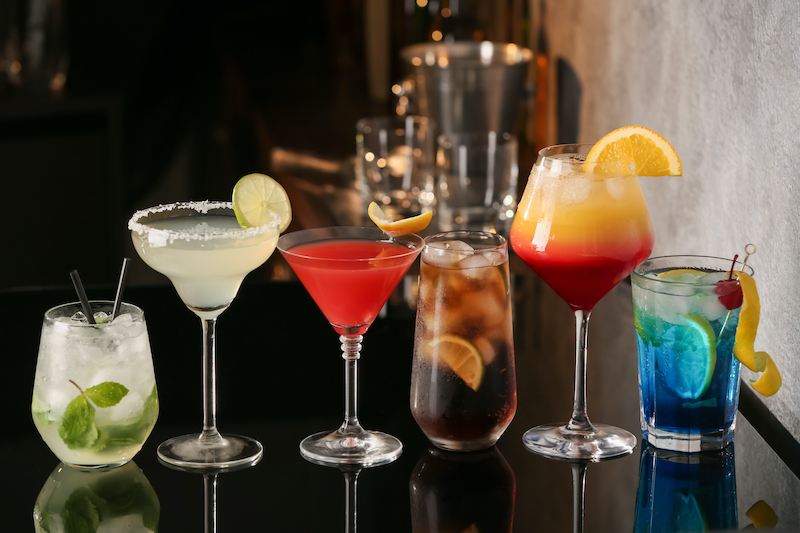 lineup of fancy cocktails made by bartender