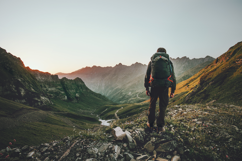 hiker overlooking mountainside