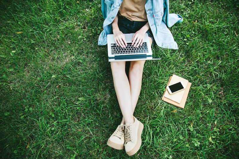 applying for a remote job on laptop in park